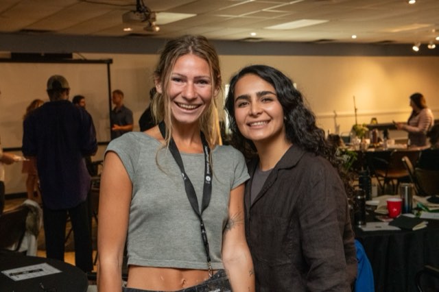 Two attendees smiling together at the Future Proof Creator Summit 2026