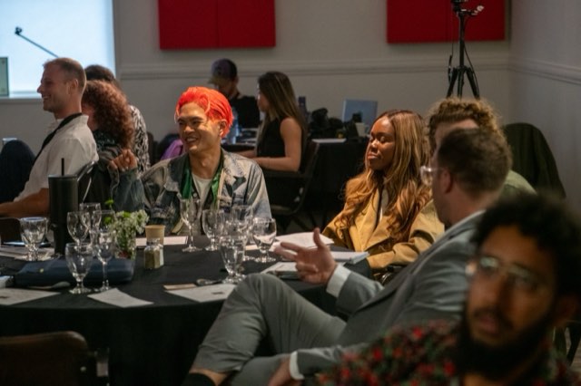 Attendees laughing together at a roundtable during the Future Proof Creator Summit 2026