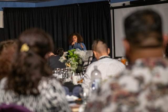 A speaker addressing the room from her seat at the Future Proof Creator Summit 2026