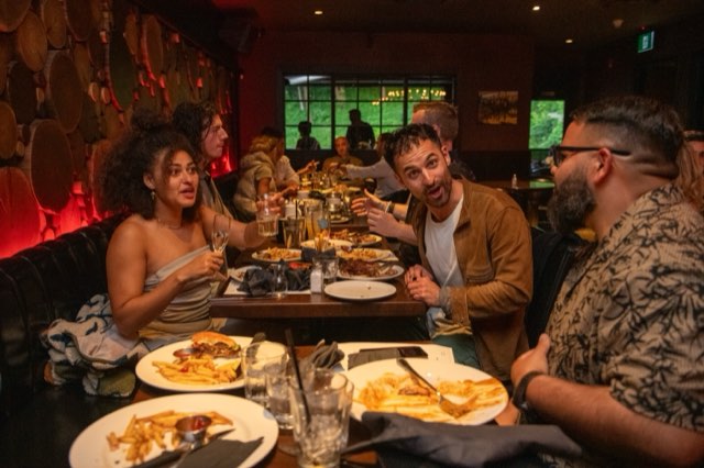 Attendees laughing over dinner at the Future Proof Creator Summit 2026