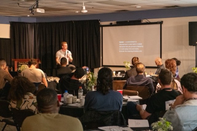 A speaker addressing the room during a workshop on career and meaning at the Future Proof Creator Summit 2026