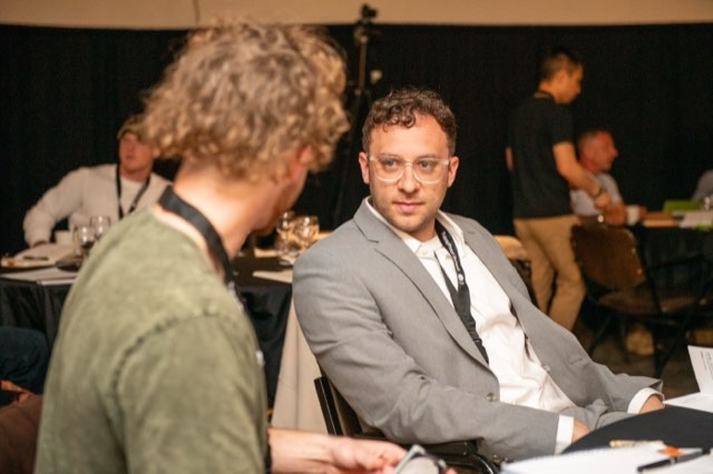 An attendee listening during a conversation at the Future Proof Creator Summit 2026
