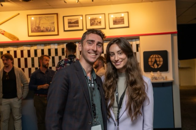Two attendees smiling together near The Living Internet Alliance sign at the Future Proof Creator Summit 2026