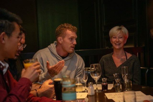 Attendees laughing together over dinner at the Future Proof Creator Summit 2026